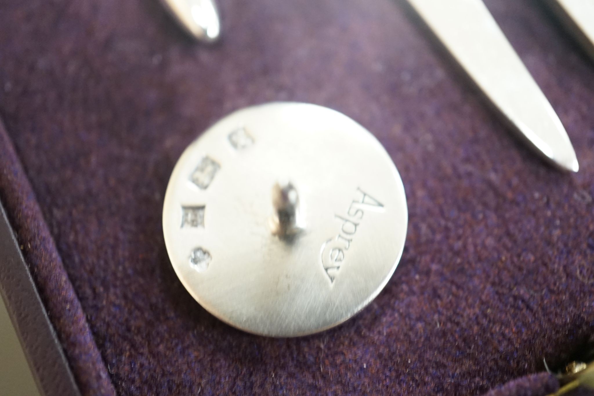 A modern Asprey cased silver golfer's companion set, comprising a tee, marker and pitch mark repairer, together with a set of six metal duck menu holders.